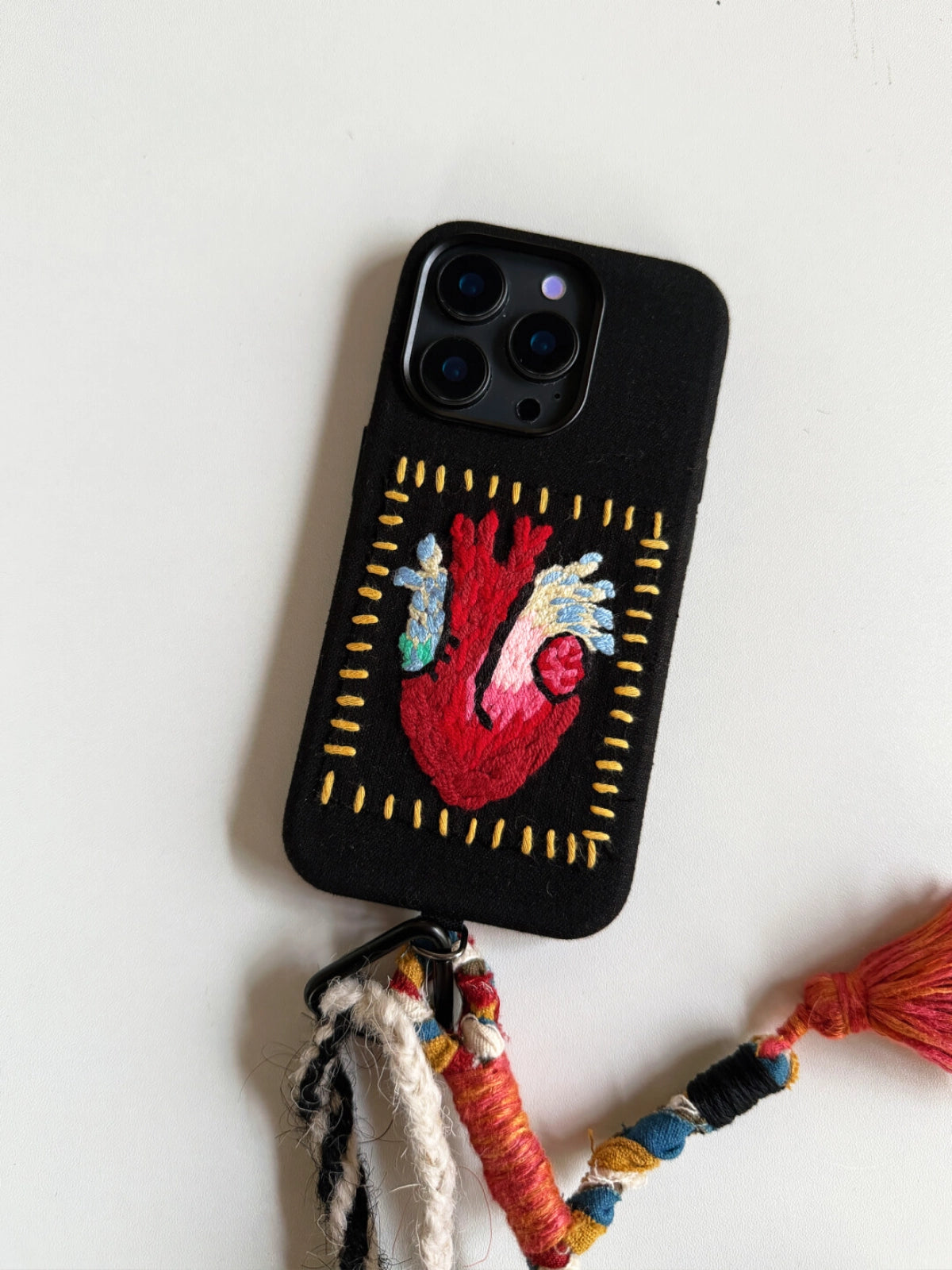 Embroidered Heart Phone Case by TRLab Shop featuring colorful heart embroidery on a protective phone cover.
