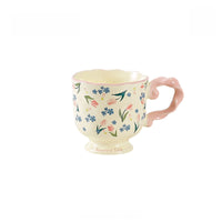 Floral twisted-handle ceramic mug by TRLab Shop with colorful floral pattern and ergonomic twisted handle.