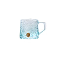 Glacier-textured gradient glass mug by TRLab Shop featuring a frosted, icy design and smooth handle on clear glass.