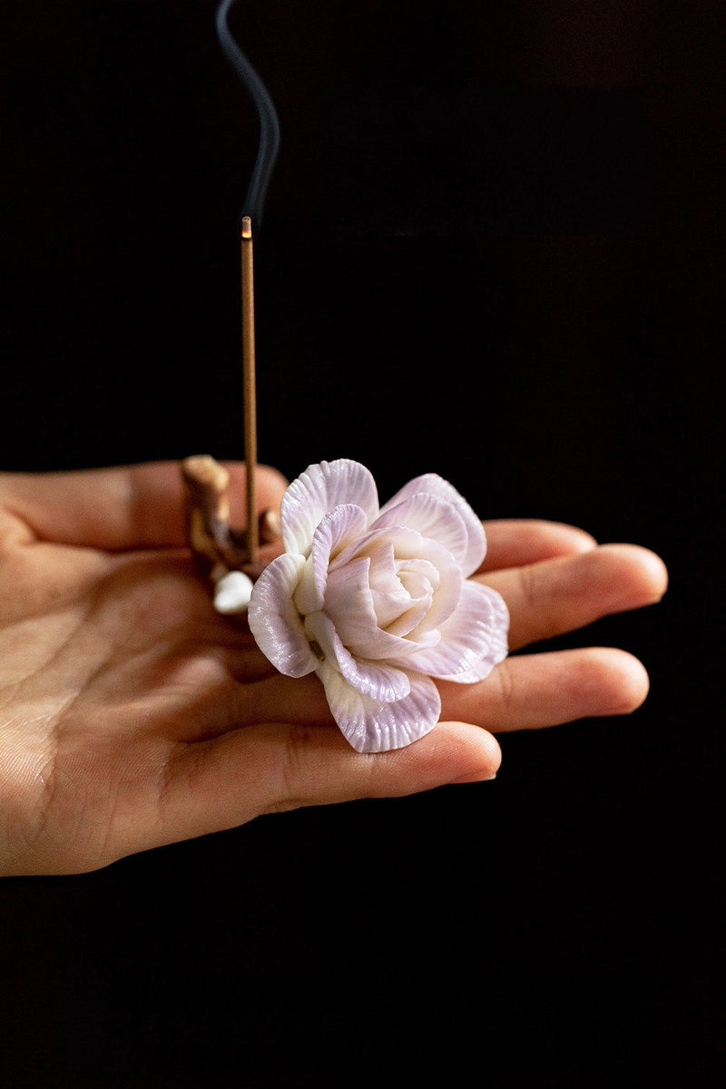Handcrafted purple-pink camellia incense holder with detailed floral design, perfect for holding incense sticks in a decorative display.
