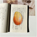 Translucent fruit-shaped acrylic bookmark with colorful fruit illustrations, ideal for marking pages in books.
