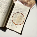 Translucent fruit-shaped acrylic bookmark with colorful fruit illustrations, ideal for marking pages in books.
