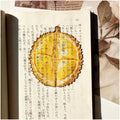 Translucent fruit-shaped acrylic bookmark with colorful fruit illustrations, ideal for marking pages in books.