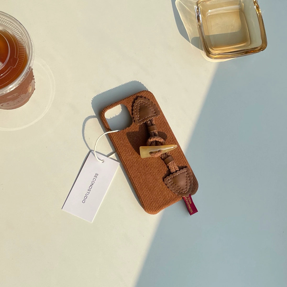 TRLab Shop striped corduroy fabric phone case with toggle button, featuring a stylish design and secure fit.