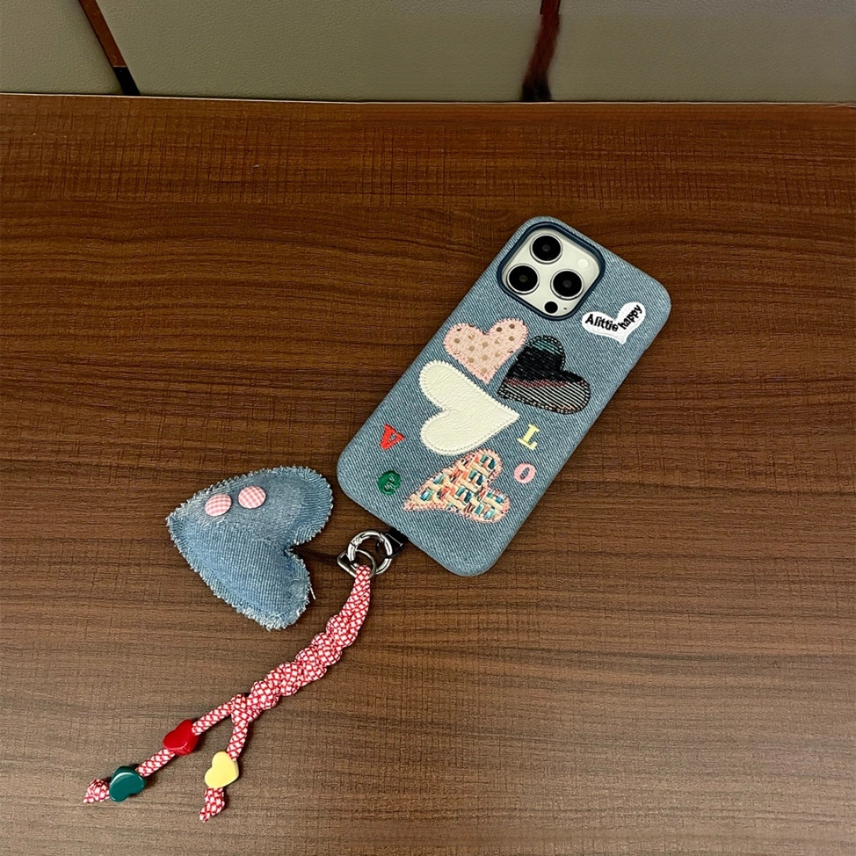 Love Heart embroidered phone case by TRLab Shop featuring a colorful love heart design on a protective phone cover.