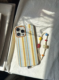 Striped fabric phone case by TRLab Shop showing a colorful, woven design with a snug fit for a smartphone.