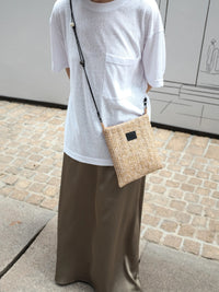Beaded straw crossbody bag with adjustable strap and intricate beadwork, featuring a boho-inspired design by TRLab Shop.