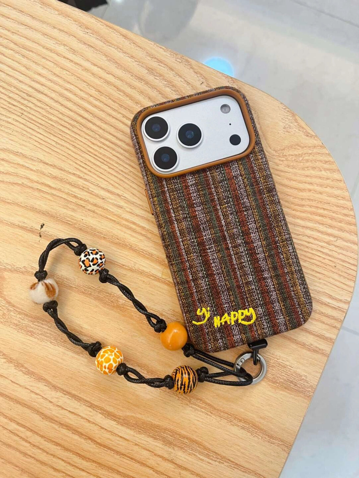 Embroidered phone case featuring colorful happy letters design, designed by TRLab Shop for a stylish protective accessory.