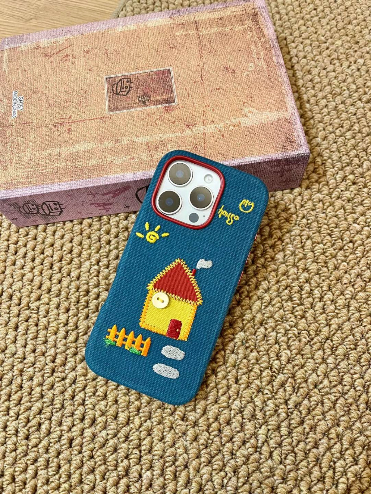 Embroidered house phone case by TRLab Shop with colorful floral embroidery, made to protect and personalize your smartphone.
