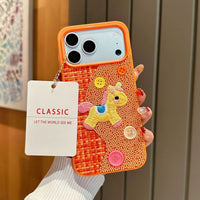 Tweed plaid embroidered unicorn phone case by TRLab Shop, featuring colorful unicorn design and textured fabric.