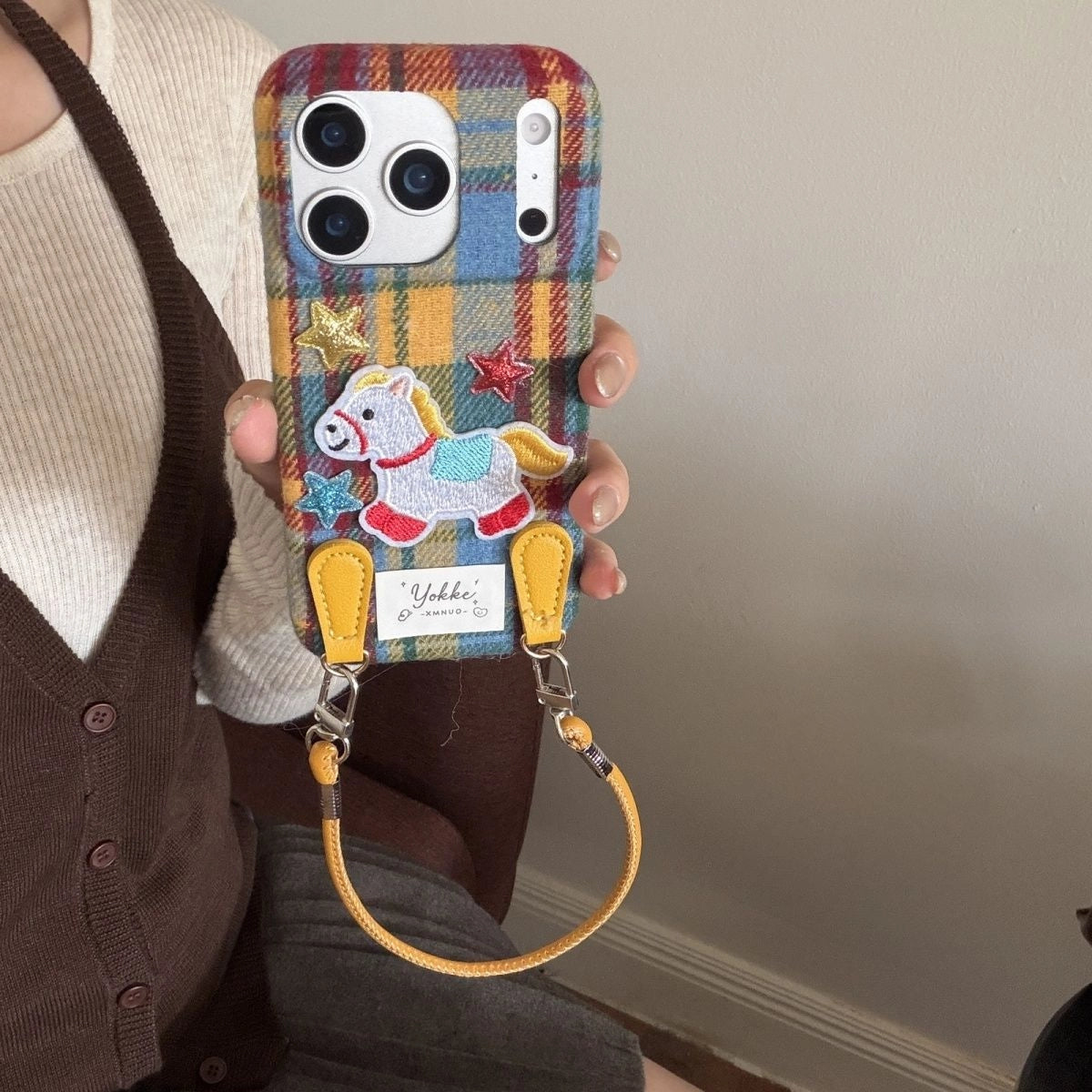 Plaid Pony embroidered phone case featuring a colorful plaid pattern and a cute pony embroidery design.