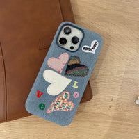 Love Heart embroidered phone case by TRLab Shop with colorful heart designs on a soft fabric surface.