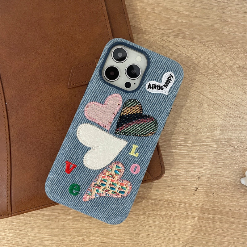 Love Heart embroidered phone case by TRLab Shop with colorful heart designs on a soft fabric surface.