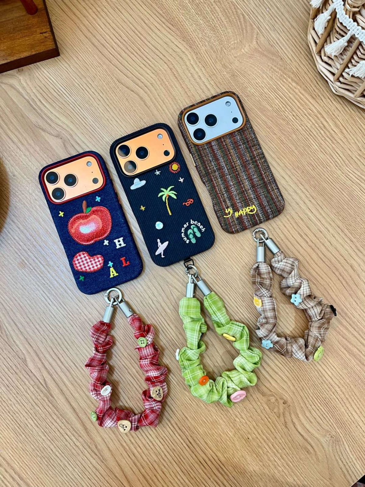 Embroidered Happy Letters phone case by TRLab Shop, featuring colorful stitched lettering on a protective smartphone cover.
