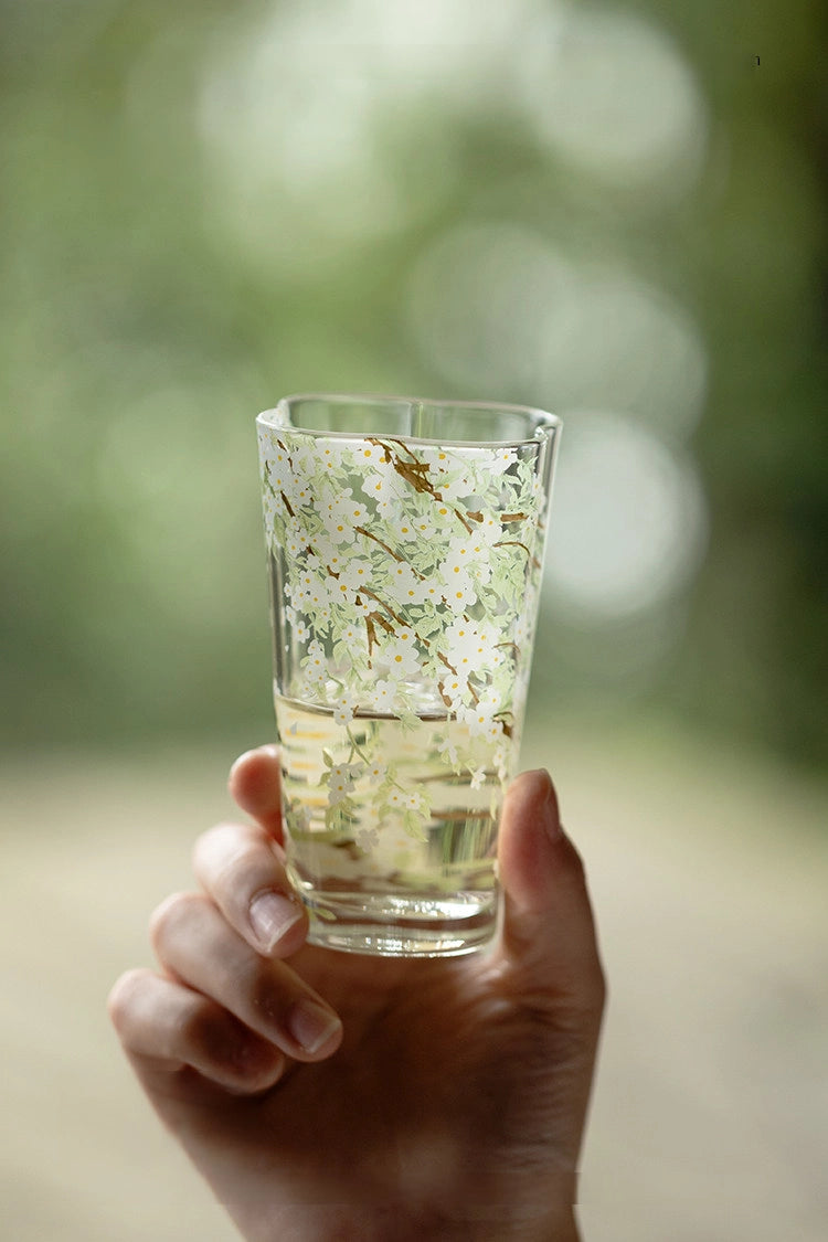 Pear-blossom glass tumbler by TRLab Shop, clear with delicate pear blossom design, ideal for beverages or decorative use.