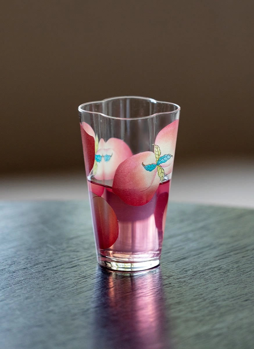 Spring Peach glass tumbler and cold brew bottle from TRLab Shop, featuring a clear glass design with peach accents and a sleek shape.