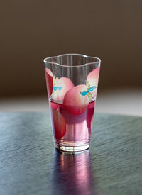 Spring Peach glass tumbler and cold brew bottle from TRLab Shop, featuring a clear glass design with peach accents and a sleek shape.