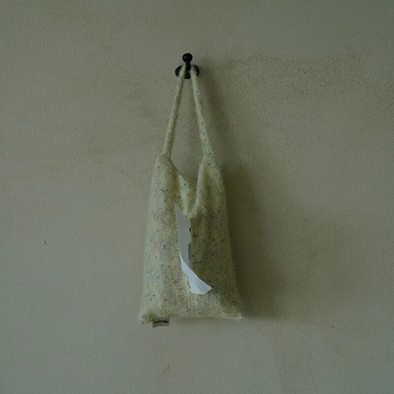 Knitted-handle tissue pack with soft tissue visible, featuring a stylish knitted fabric handle for easy carrying.