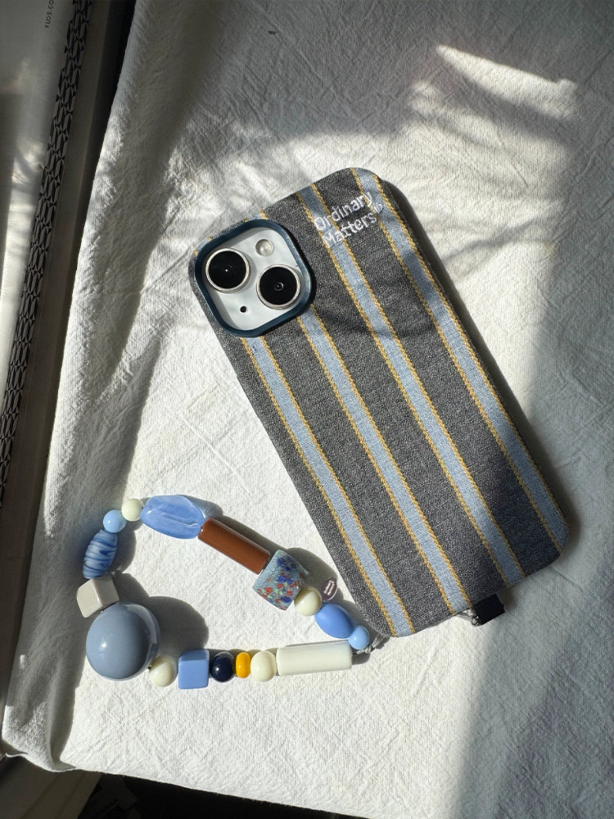 Striped fabric phone case by TRLab Shop with colorful horizontal stripes and soft material, designed to protect and style your phone.
