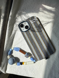 Striped fabric phone case by TRLab Shop with colorful horizontal stripes and soft material, designed to protect and style your phone.