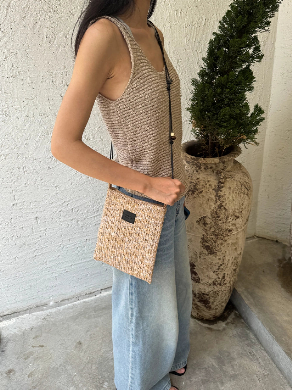 Beaded straw crossbody bag with colorful beads and adjustable strap, stylish accessory for casual and summer outfits.