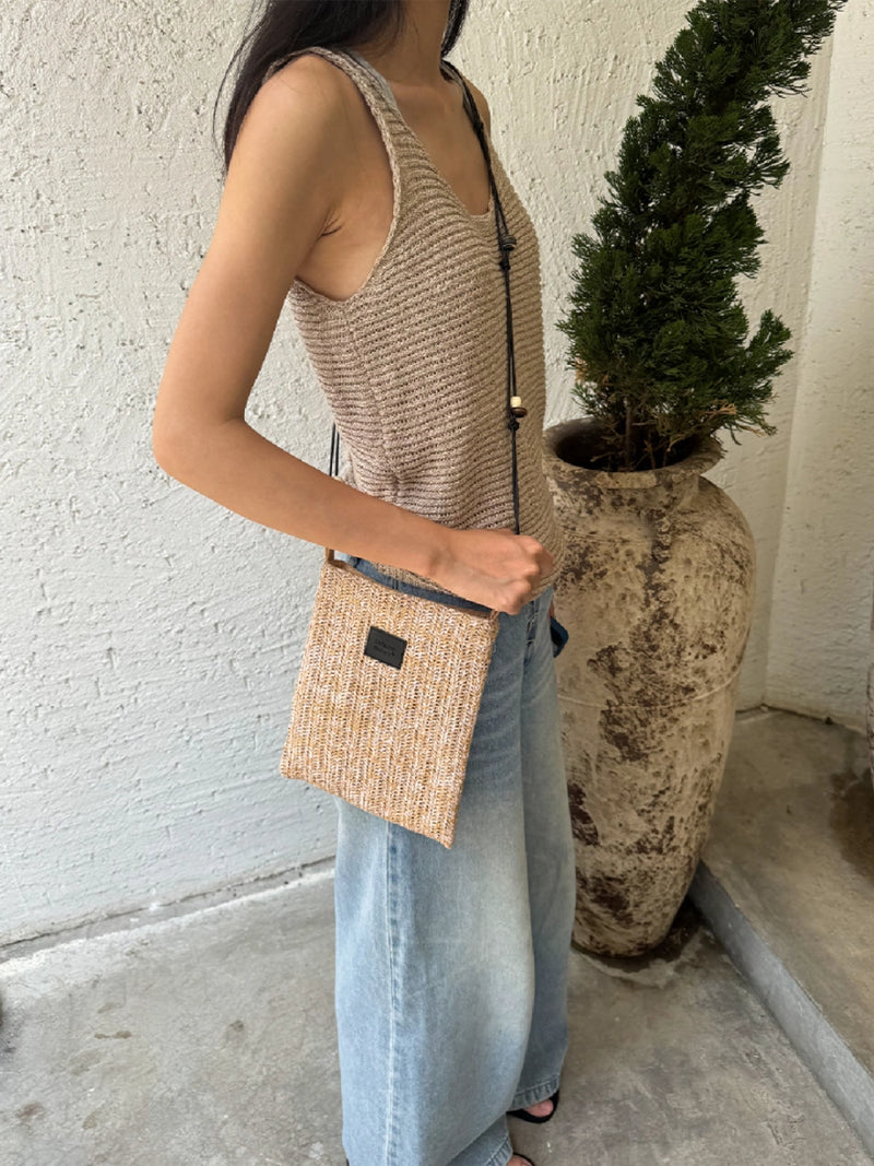 Beaded straw crossbody bag with colorful beads and adjustable strap, stylish accessory for casual and summer outfits.
