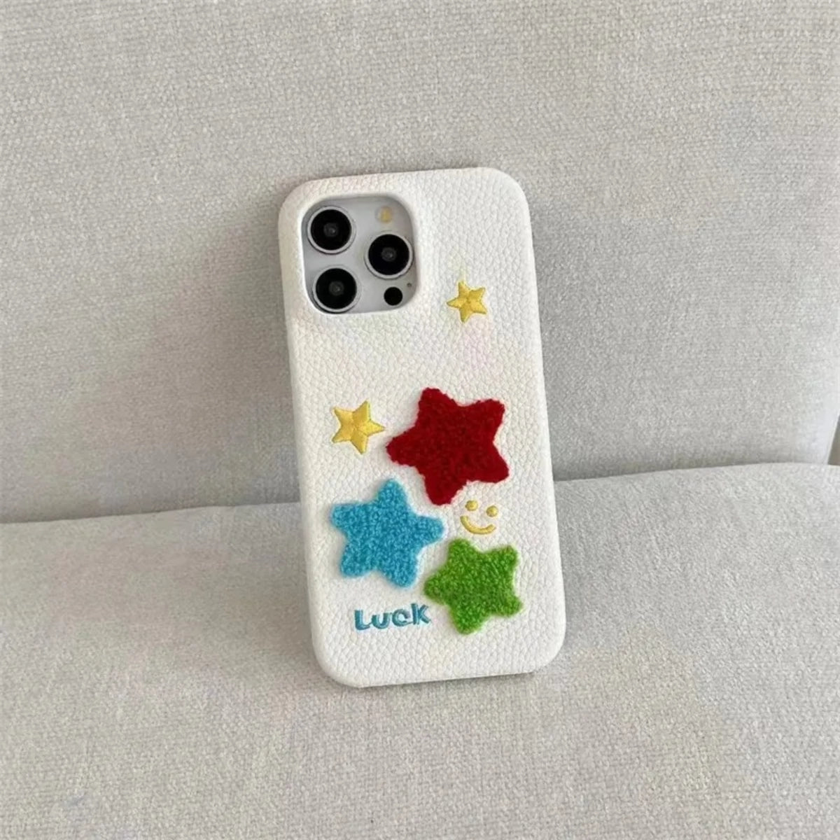 Leather Terry Star embroidered phone case by TRLab Shop featuring a textured leather surface with star embroidery.