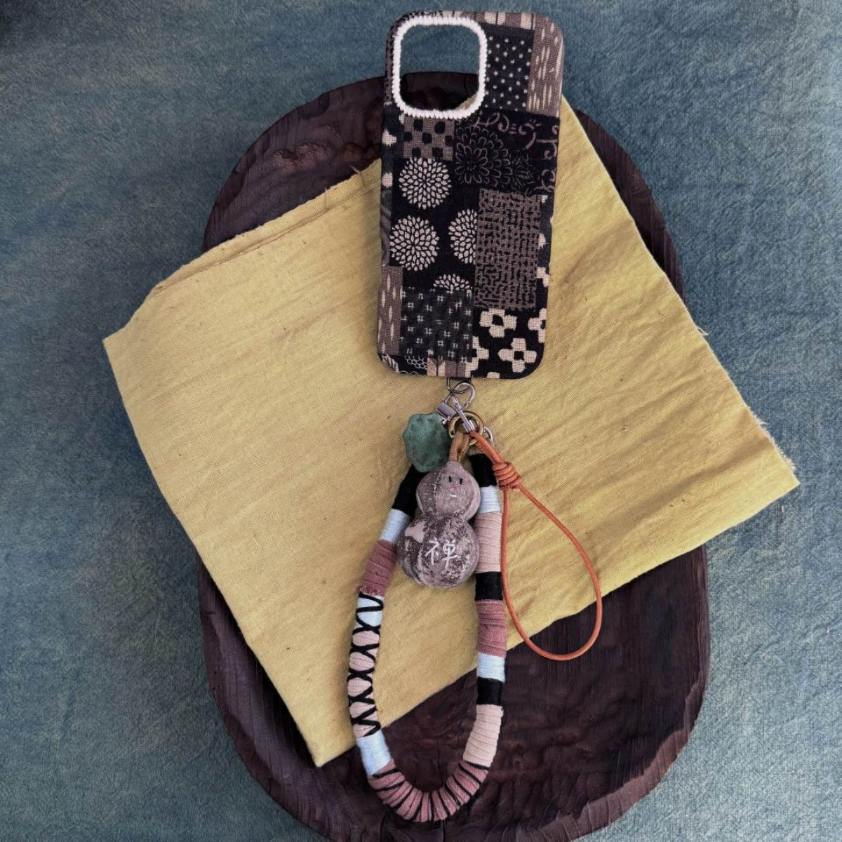 Tie-dyed fabric phone case by TRLab Shop with vibrant, colorful tie-dye pattern and soft fabric texture.