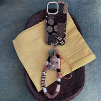 Tie-dyed fabric phone case by TRLab Shop with vibrant, colorful tie-dye pattern and soft fabric texture.