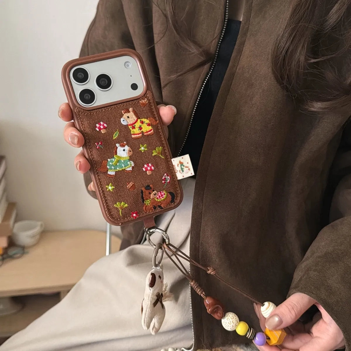 Embossed TRLab Shop embroidered pony phone case with colorful stitching and detailed pony design for iPhone or Android.