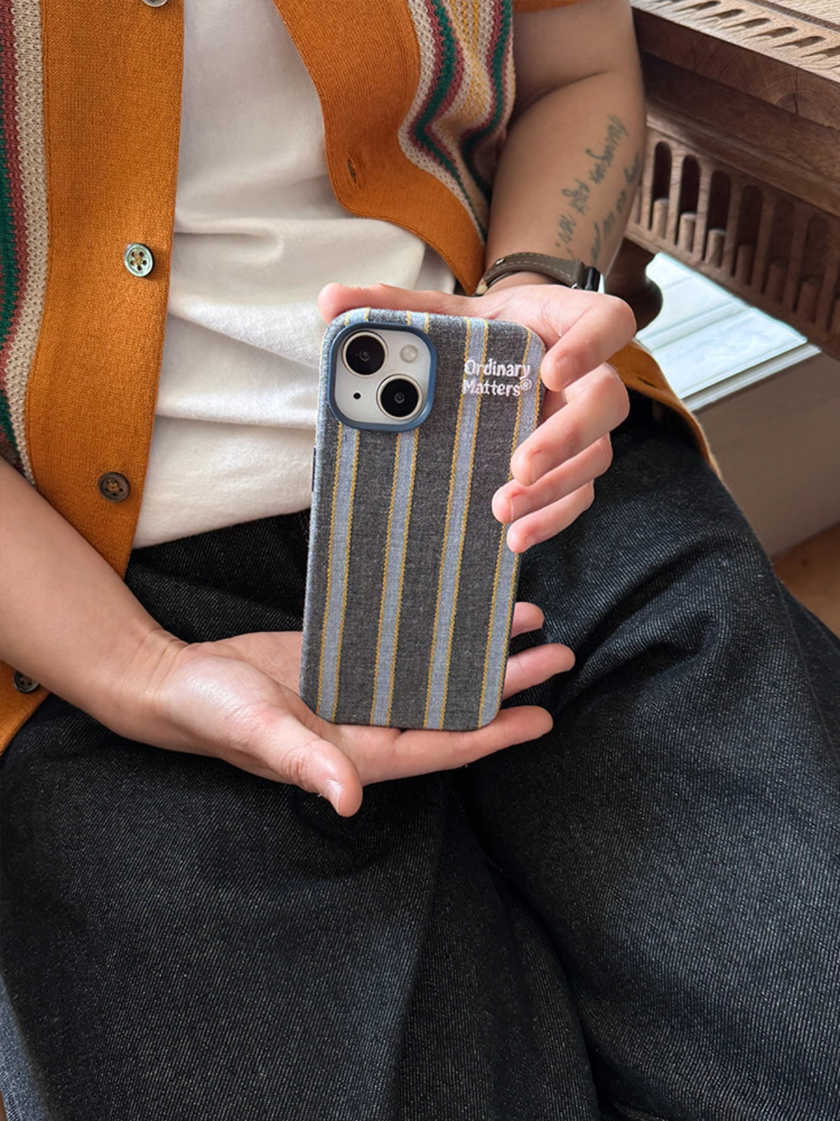 Striped fabric phone case by TRLab Shop with colorful horizontal stripes, soft texture, and snug fit for smartphones.