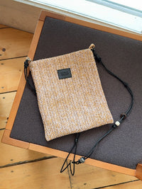 Beaded straw crossbody bag with colorful bead accents, adjustable strap, and compact design by TRLab Shop.