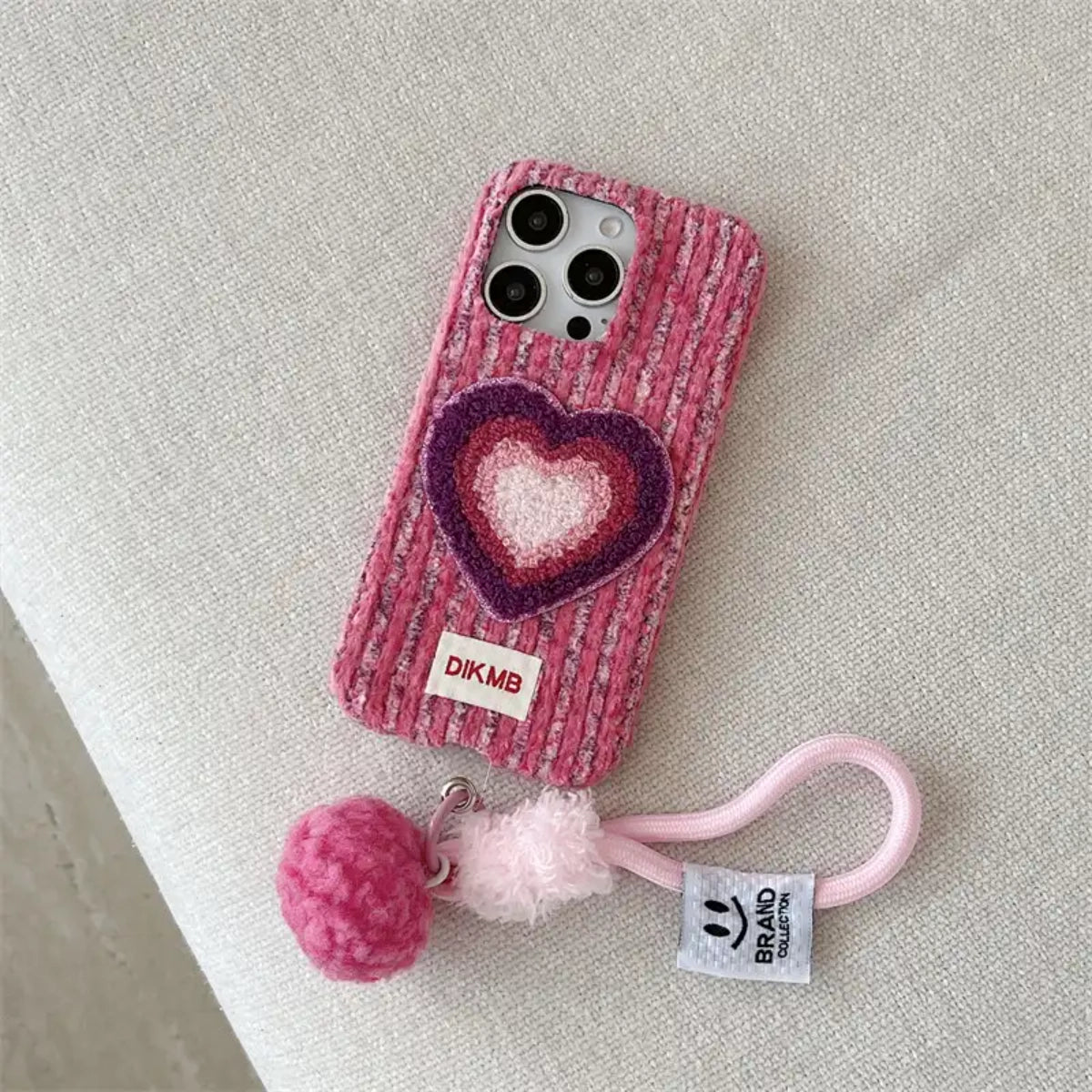Pink Love Heart embroidered phone case by TRLab Shop with heart-shaped embroidery on soft pink background.
