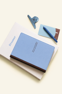 Blue refillable notebook by Square Studio with a soft cover and blank pages, ideal for journaling or note-taking.