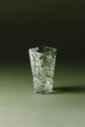 Pear-blossom glass tumbler by TRLab Shop with a delicate floral design, clear glass body, and smooth rounded shape.