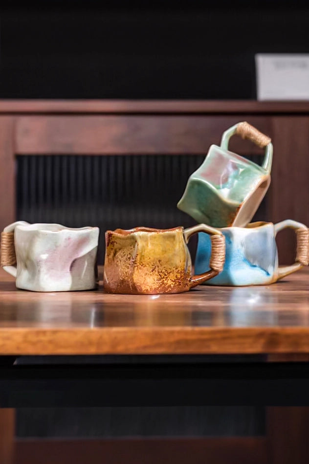 TRLab Shop ceramic mug with rope handle, white glazed finish, and sturdy design for hot beverages.