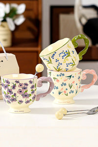 Floral twisted-handle ceramic mug with colorful flower design, durable white ceramic, ideal for hot beverages.