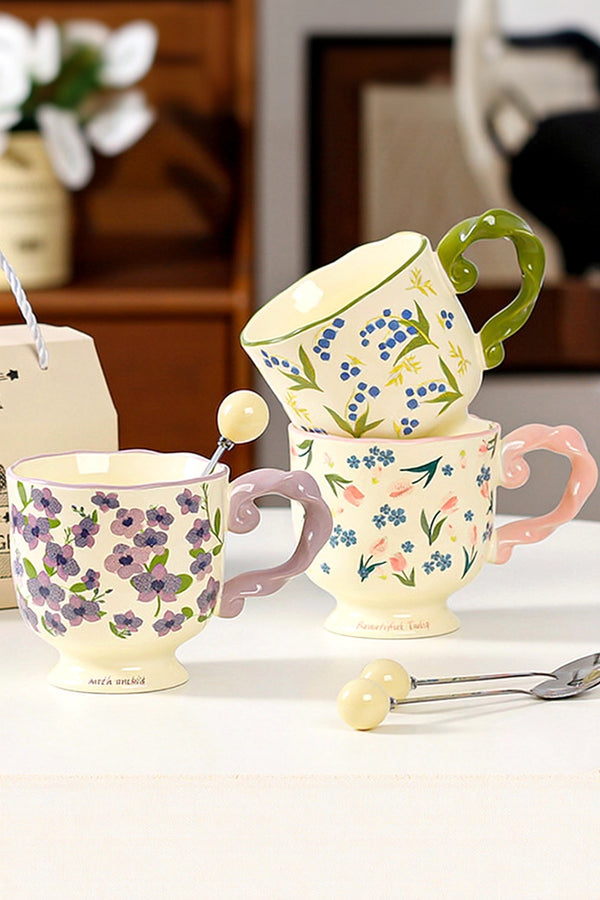 Floral twisted-handle ceramic mug with colorful flower design, durable white ceramic, ideal for hot beverages.