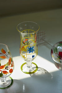 Hand-painted glass vase with colorful floral design, showcasing intricate artwork and transparent glass texture.