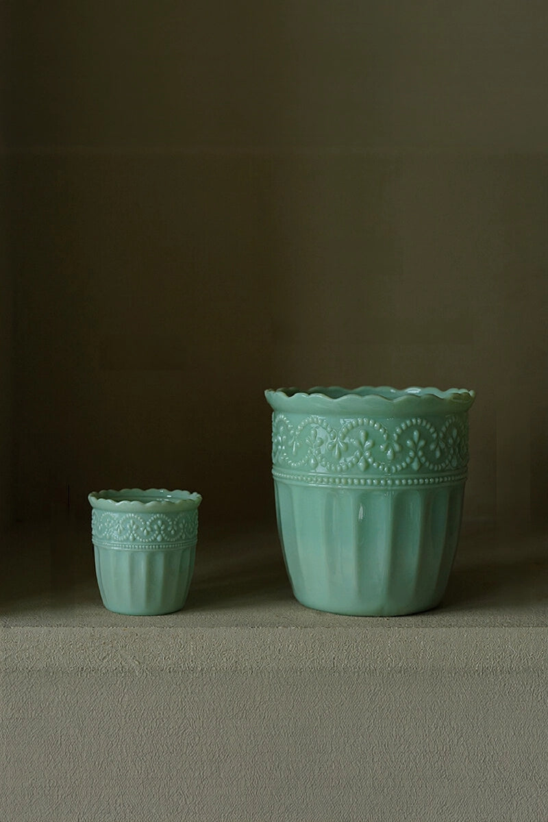 Elegant milk glass embossed vase with floral patterns, showcasing intricate details and craftsmanship.