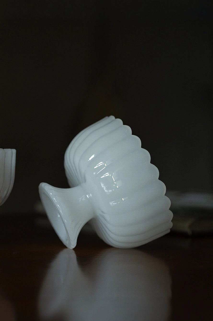Milky-white glass bowl with smooth, rounded edges and a glossy finish, perfect for serving or decorative use.