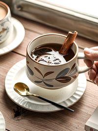 Retro floral ceramic coffee cup and saucer set with colorful floral design, perfect for vintage-style coffee serving.