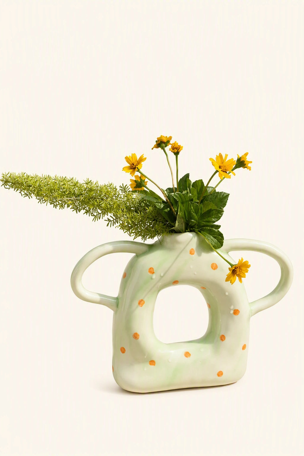 Set of five ceramic donut-shaped vases with twin handles from UNBELDI, featuring colorful, textured designs for decorative display.