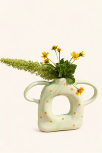Set of five ceramic donut-shaped vases with twin handles from UNBELDI, featuring colorful, textured designs for decorative display.