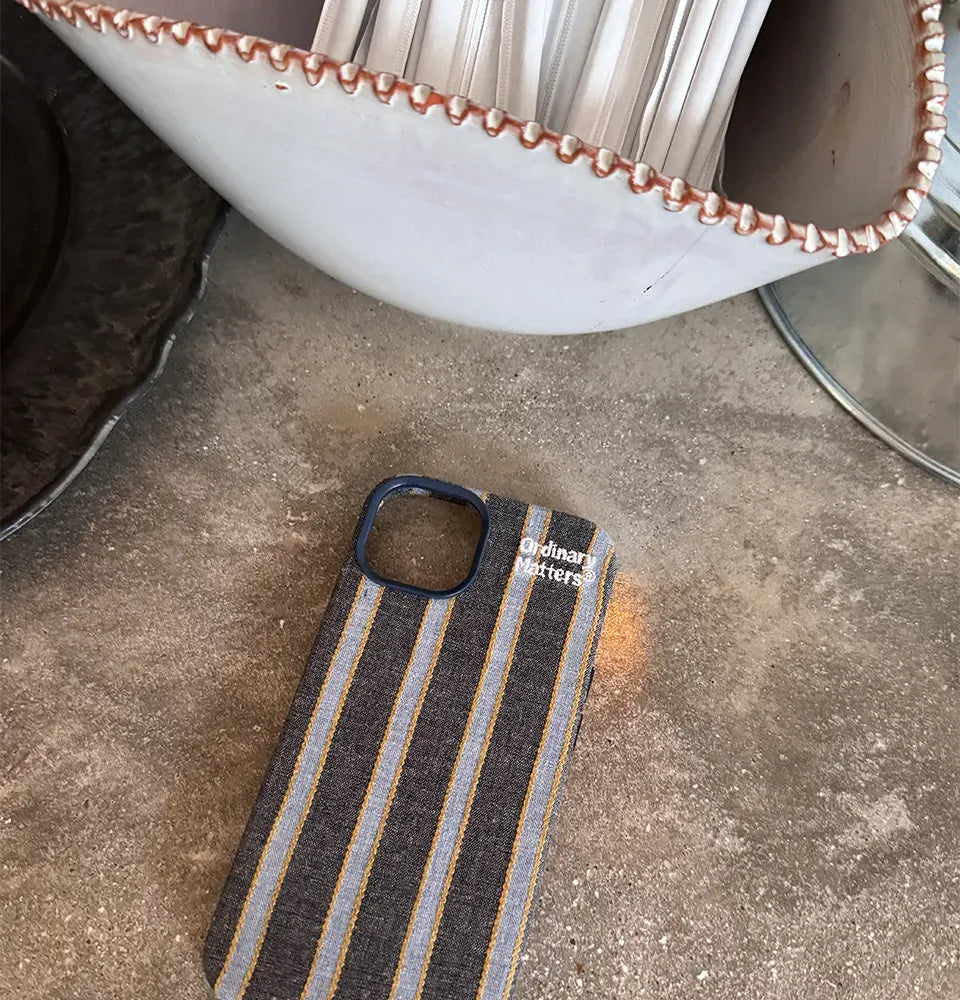 Striped fabric phone case from TRLab Shop, showing a colorful textile design fitting a smartphone.