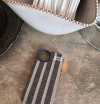 Striped fabric phone case from TRLab Shop, showing a colorful textile design fitting a smartphone.